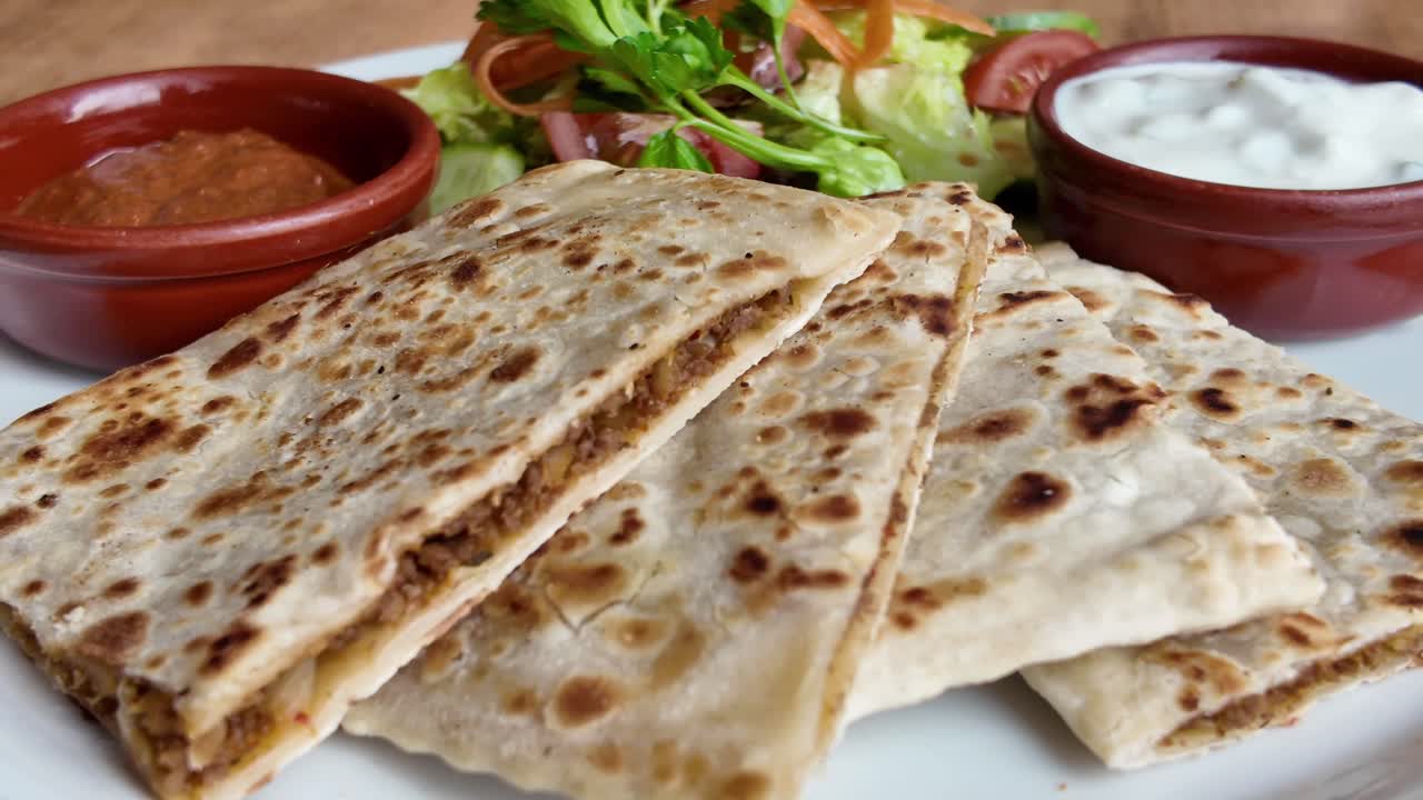 Delicious Stuffed Flatbread Served with Fresh Salad and Dips