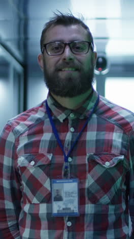 it professional smiling in a server room with an id badge