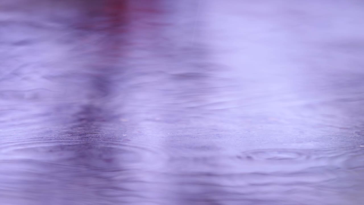 Rain Drops Falling To Asphalt