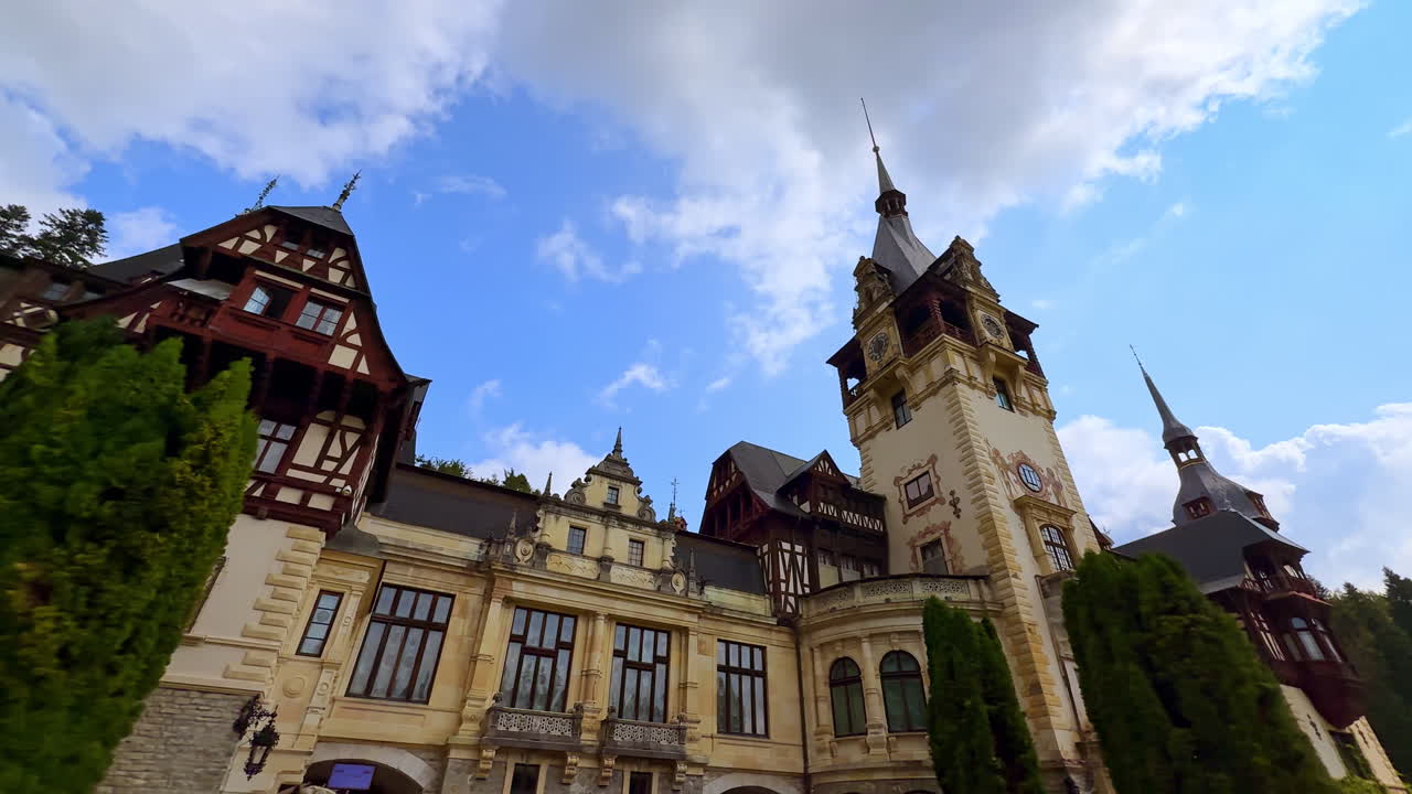 Sinaia, Romania, 17 July 2025: Main tower of Peles Castle in Sinaia Romania. View of the central tower of Peles Castle in Sinaia Romania with gothic architecture and blue sky