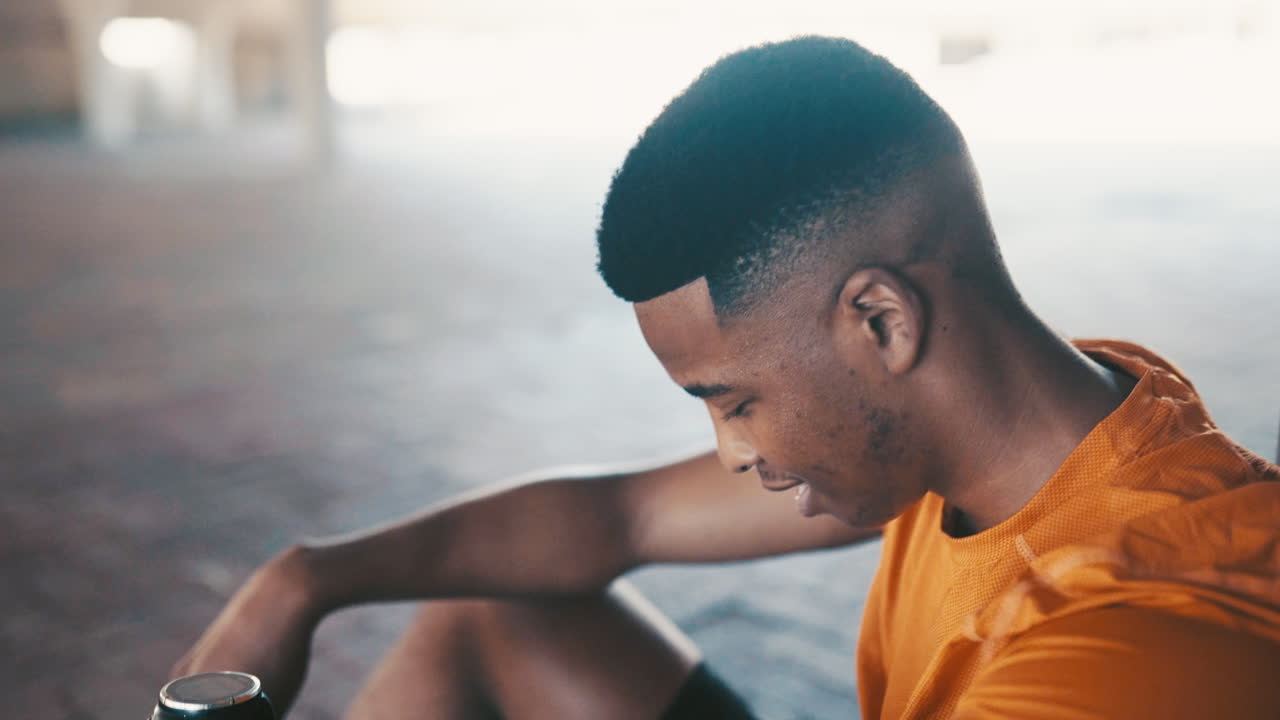 a sporty young man taking a break while exercising