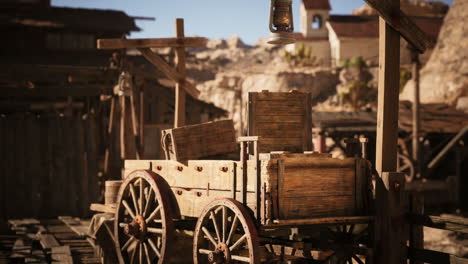 antique wooden cart with lantern in an old western town at sunset