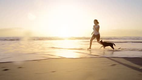 woman running dog on beach lifestyle steadicam shot