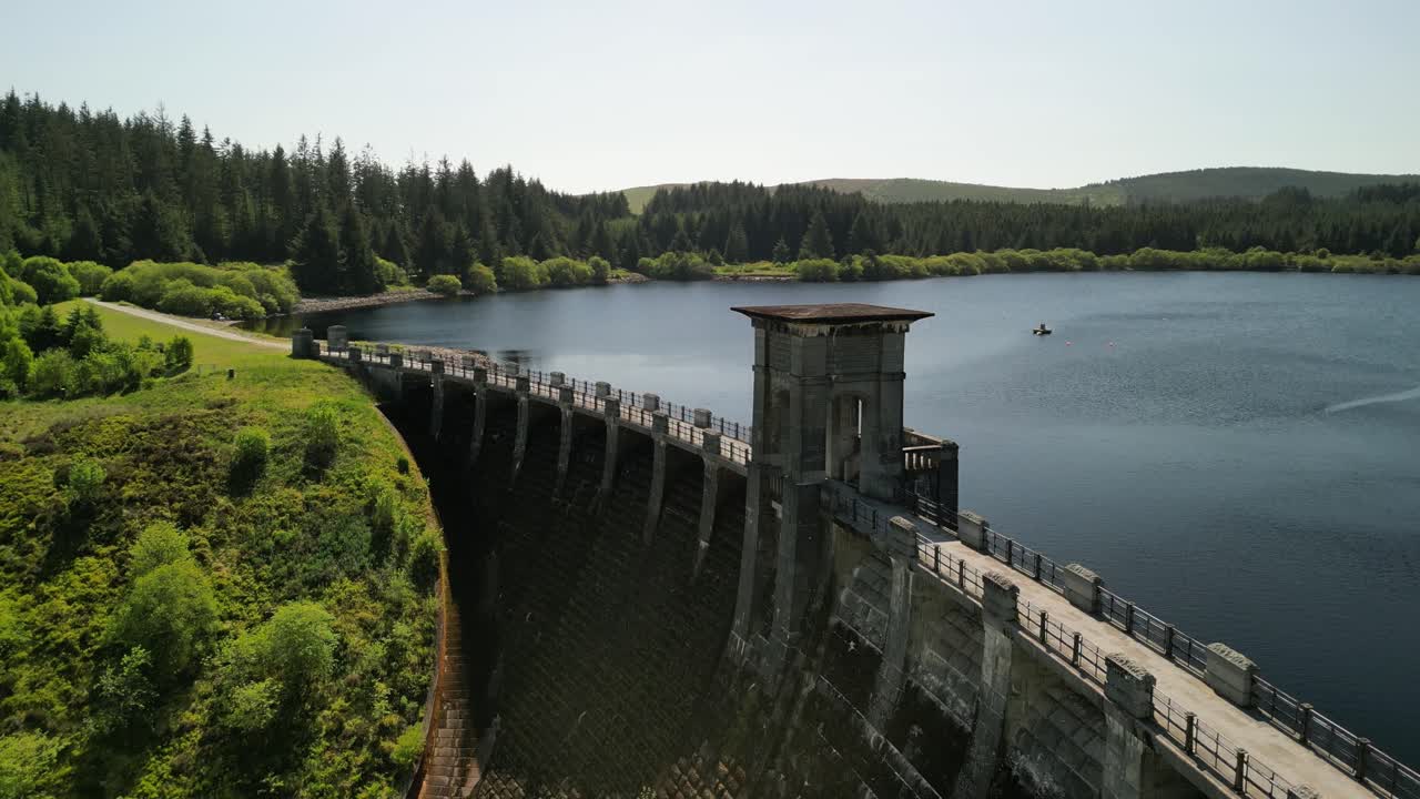 Alwen Reservoir dam Conwy, Wales - Aerial drone rise and reverse , focus on dam and reveal lake - June 23