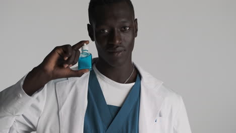 African american doctor on grey background.
