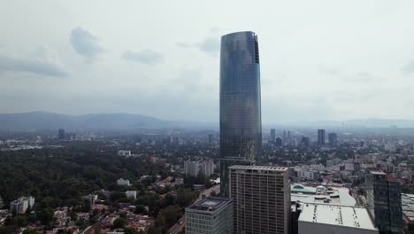 Aerial-Rising-View-Of-Centro-Comercial-Mítikah-With-Cityscape-View-In-Background-In-Mexico-City