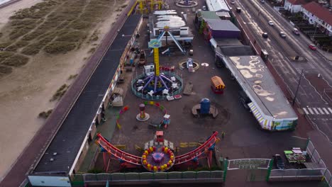 children's amusement park beside highway at great yarmouth, norfolk - aerial drone shot