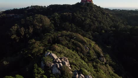 drone flying above castelo dos mouros above the town of sintra, lisbon, portugal