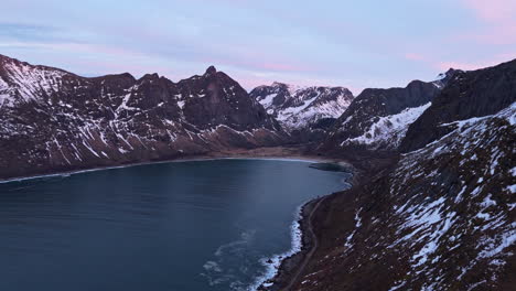 majestic arctic fjord in senja, norway, with snow-covered mountains at dusk