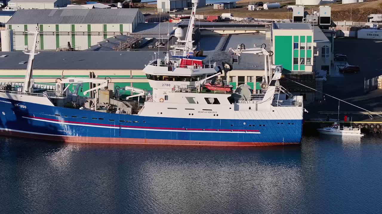 The stunning vessel stood out against the breathtaking backdrop of crystal-clear waters, the City and Harbor of Hofn in Iceland.