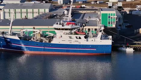 the stunning vessel stood out against the breathtaking backdrop of crystal-clear waters, the city and harbor of hofn in iceland.