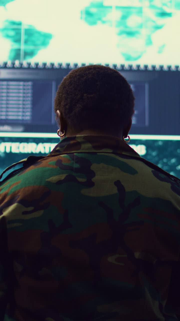 Soldier Monitoring Integrated Data Feeds in Control Room
