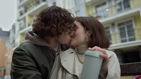 lovely couple kissing on urban background. man and woman felling happy outdoor.