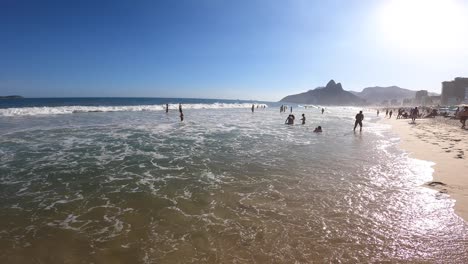 walking into ocean on famous ipanema beach in brazil