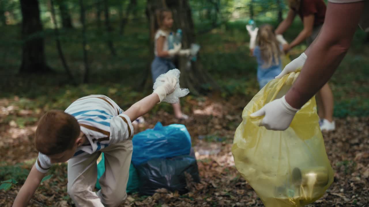 Caucasian boy cleaning forest from trashes with family.