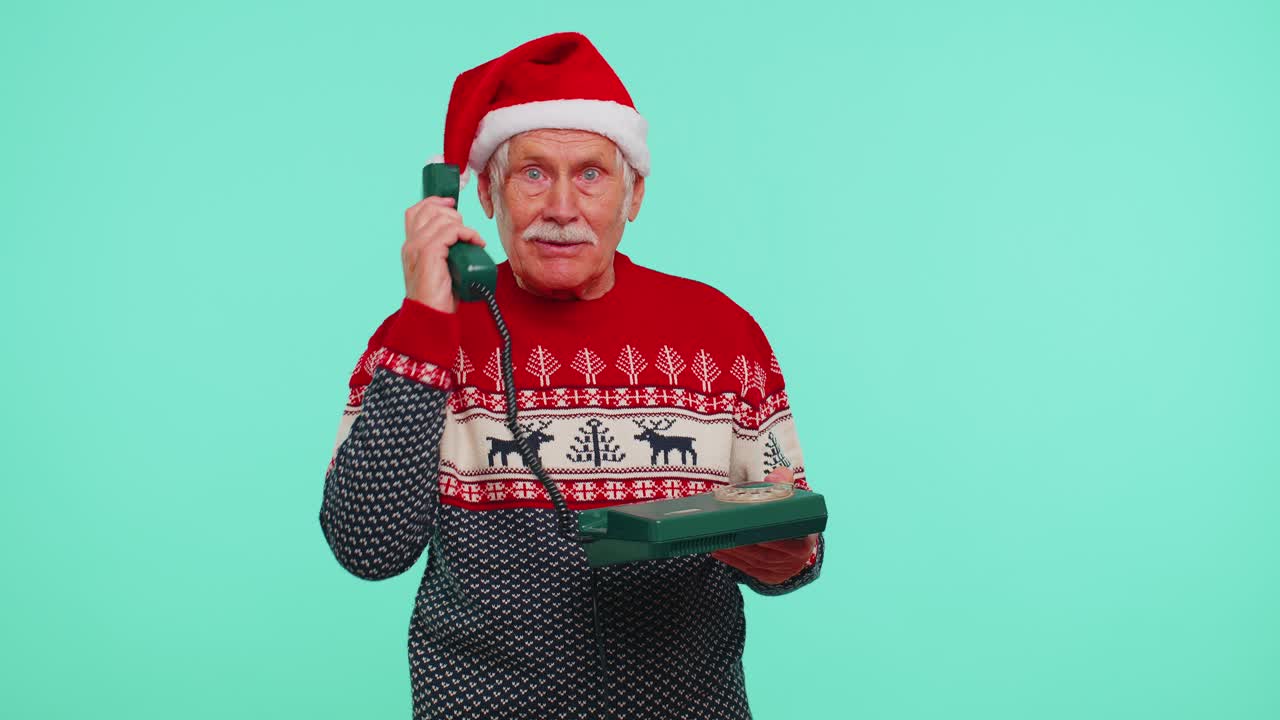 Senior christmas grandfather man talking on wired vintage telephone of 80s say hey you call me back