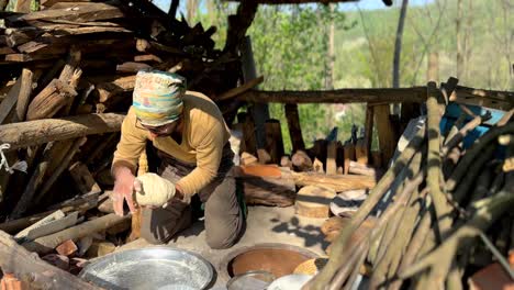 a man is making loaf of bread in a rural village forest mountain local people life in rasht gilan country side agriculture life style fresh organic wheat floor flat bread fermentation