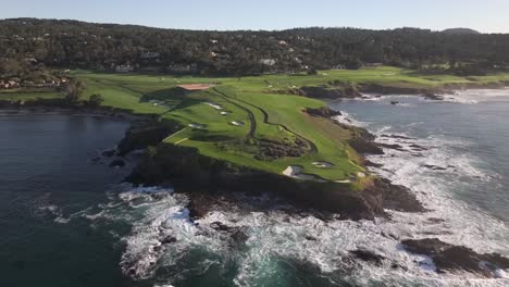 famous pebble beach golf course over 7th hole, cinematic aerial view over ocean at sunrise