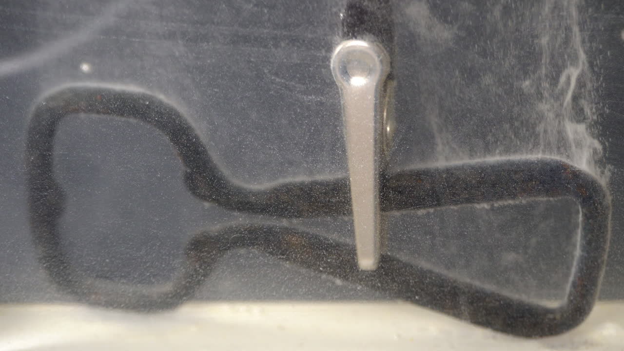 Negative electrical lead connected to metal part cleaned in electrolytic bath