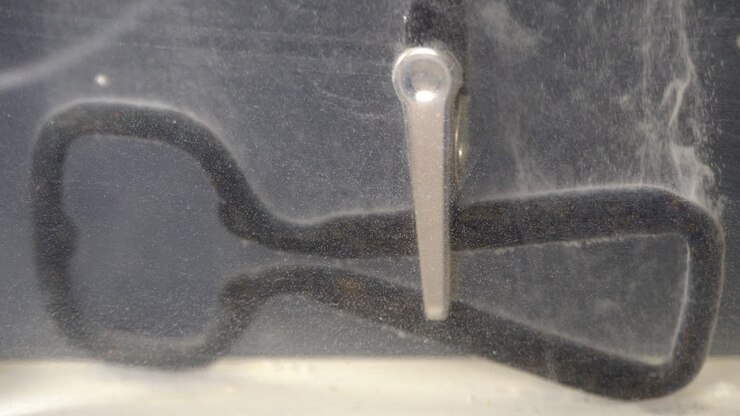 Negative electrical lead connected to metal part cleaned in electrolytic bath