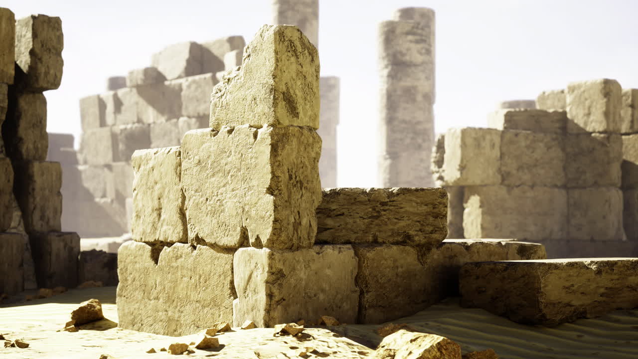 Ancient stone ruins amidst sandy landscape in bright sunlight