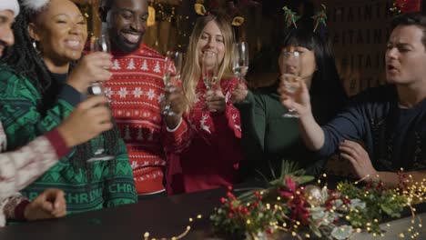 Tracking-Shot-Approaching-Friends-Bringing-Their-Drinks-Together-On-Christmas