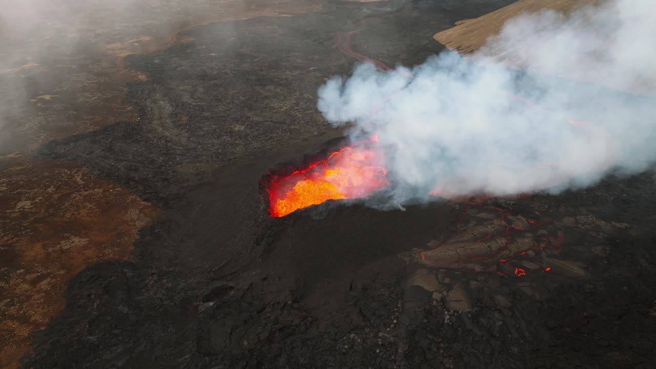 Aerial panoramic view above the volcano erupting at Litli-Hrutur, Iceland, with lava and smoke coming up