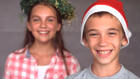 smiling siblings with christmas hat