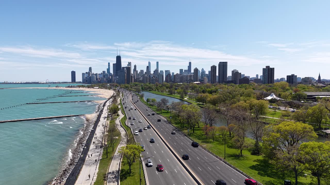 Drone Shot of Chicago USA Cityscape Skyline, Downtown Buildings and Lake Shore Drive Traffic on Sunny Day