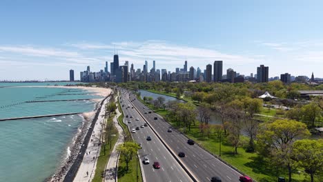 drone shot of chicago usa cityscape skyline, downtown buildings and lake shore drive traffic on sunny day