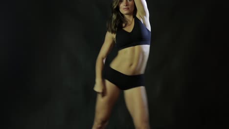 woman dancing in black sportswear