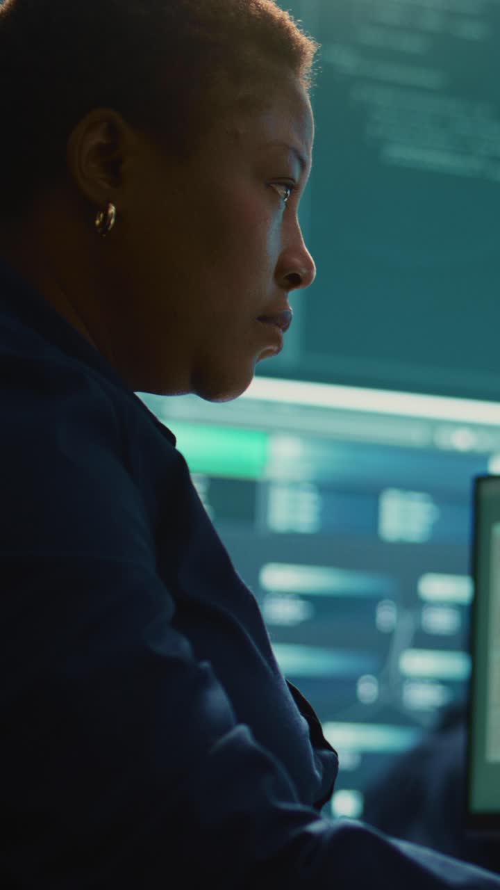 Focused Female Developer Typing Code on Computer Screen