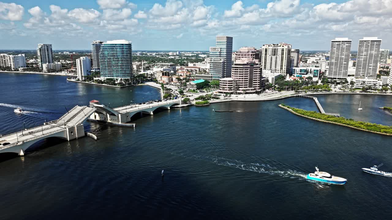 Aerial: Royal Park Bridge closing, One Flagler and Phillips Point building during the day in West Palm Beach, Florida, USA, establishing drone shot