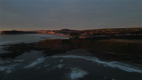 establishing aerial drone shot of cleveland way and scarborough at golden hour