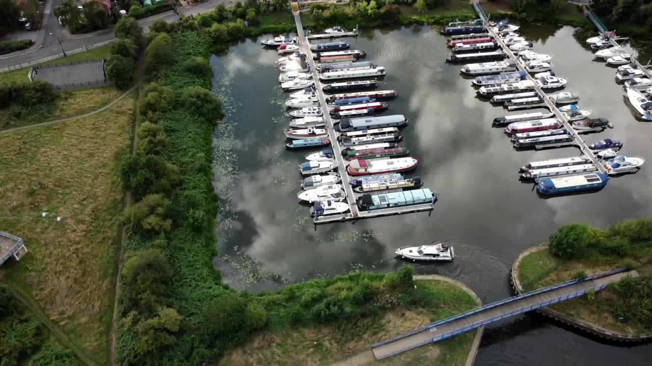 Aerial Drone video captures A River Boats entering Kings Marins in Newark. The footage rotates around this boat and it moves along.