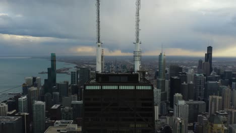 aerial, helicopter flies away from skyscraper buildings in chicago, illinois