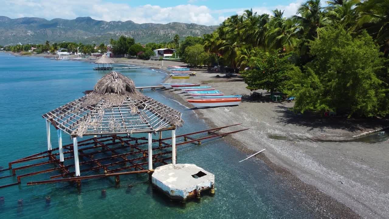 Tropical Beach Scene with Boats and Gazebo