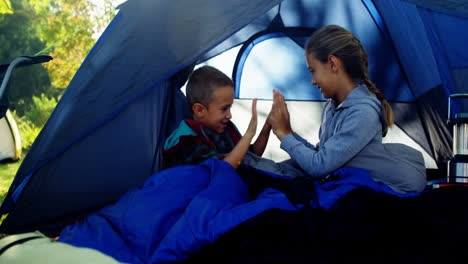 Siblings-enjoying-outside-tent