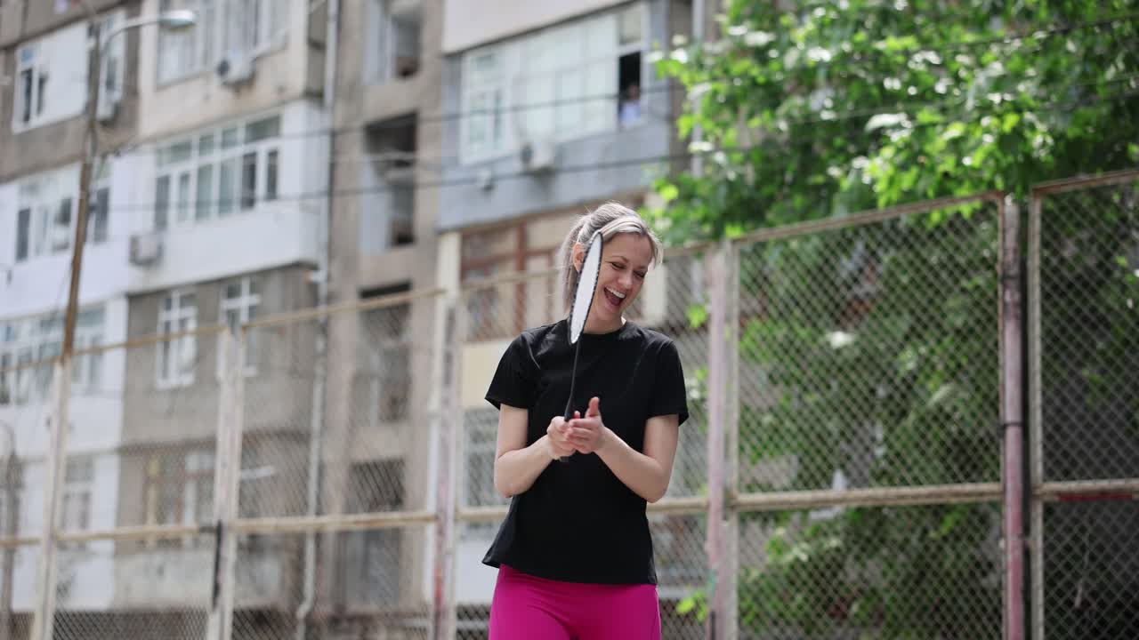 Happy Woman Playing Badminton Outdoors