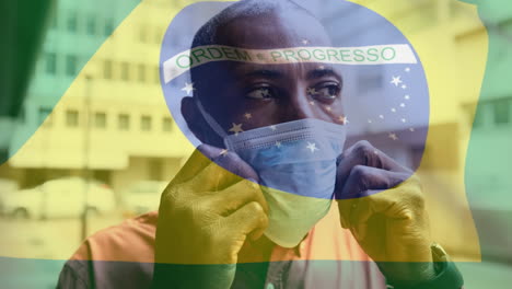 brazilian flag waving against man wearing face mask