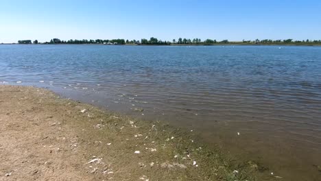 slow motion - on a beach looking out at a beach on a sunny day near a small town in alberta canada