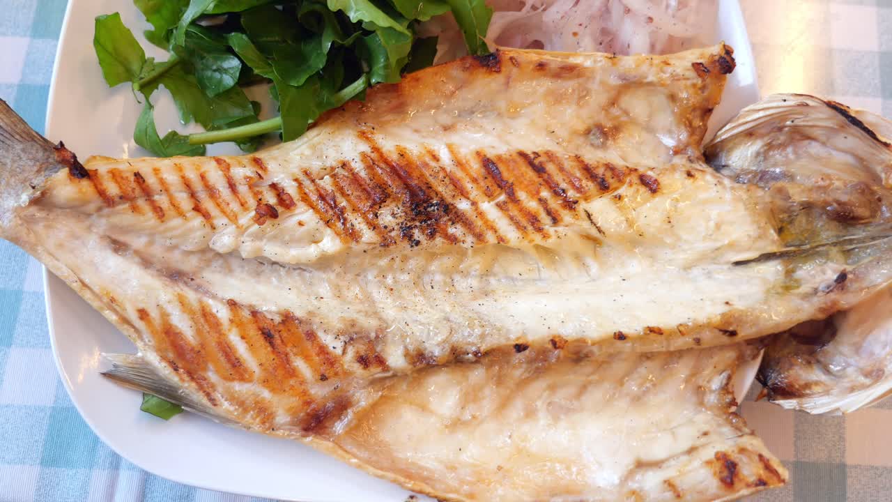 Grilled fish with greens