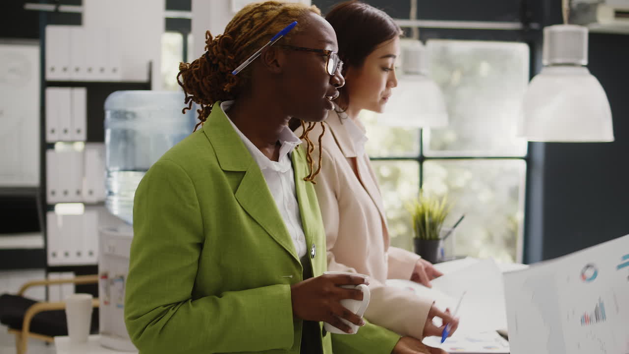 Businesswomen Discussing Documents in the Office