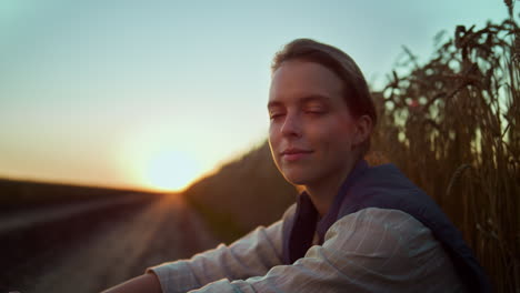 portrait woman farmer in golden sunset sunlight. worker resting after hard day.