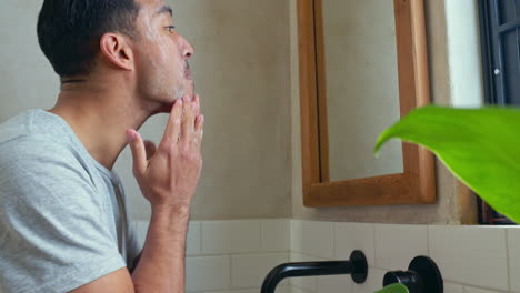 man washing his face