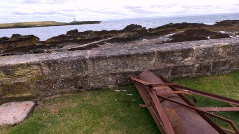 old field roller near coastal wall in scotland