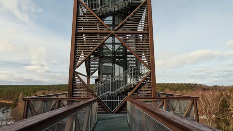 view of anyksciai laju takas, treetop walking path complex with a walkway, an information center and observation tower, located in anyksciai, lithuania near sventoji river