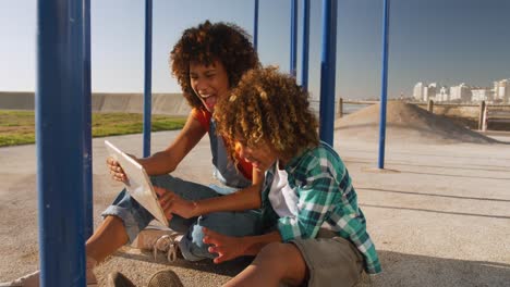 Mutter-Und-Sohn-Nutzen-Digitales-Tablet-Auf-Dem-Spielplatz