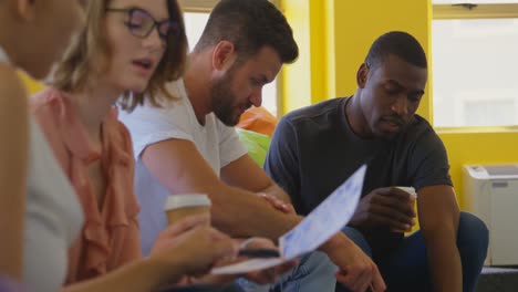 young mixed race business team discussing over document in modern office 4k