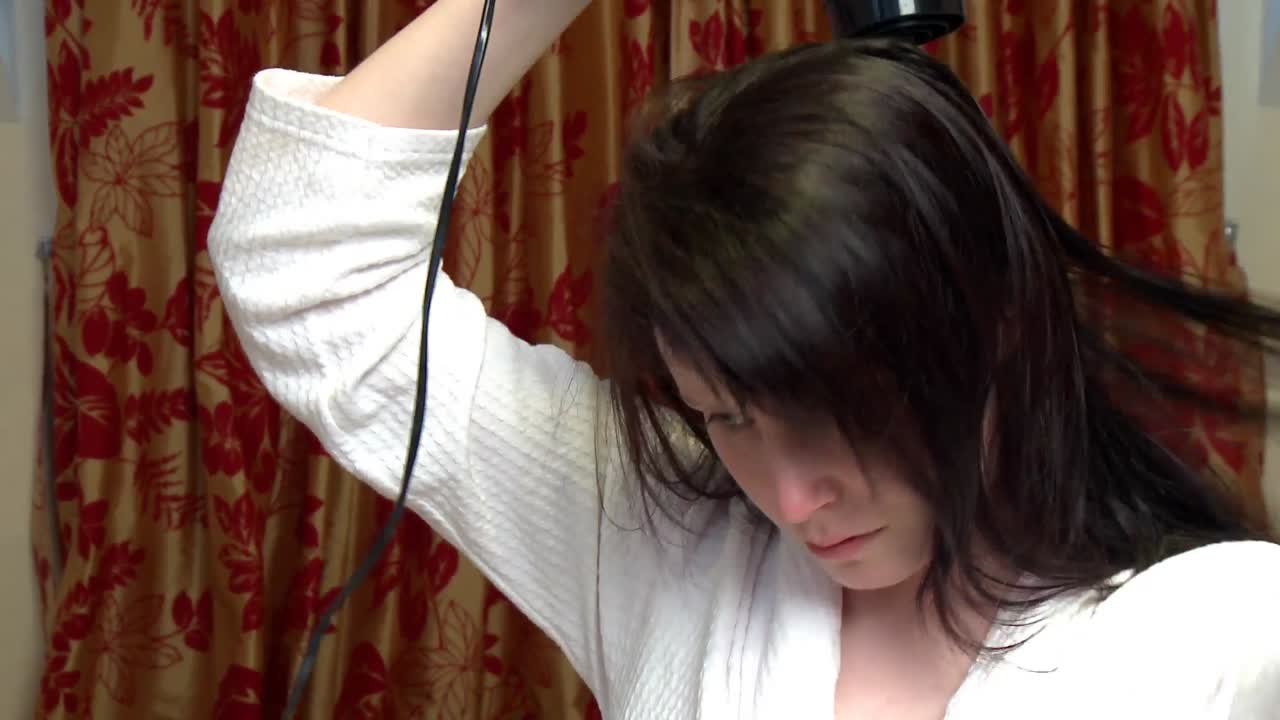 머리카락을 건조시키는 아름다운 여성